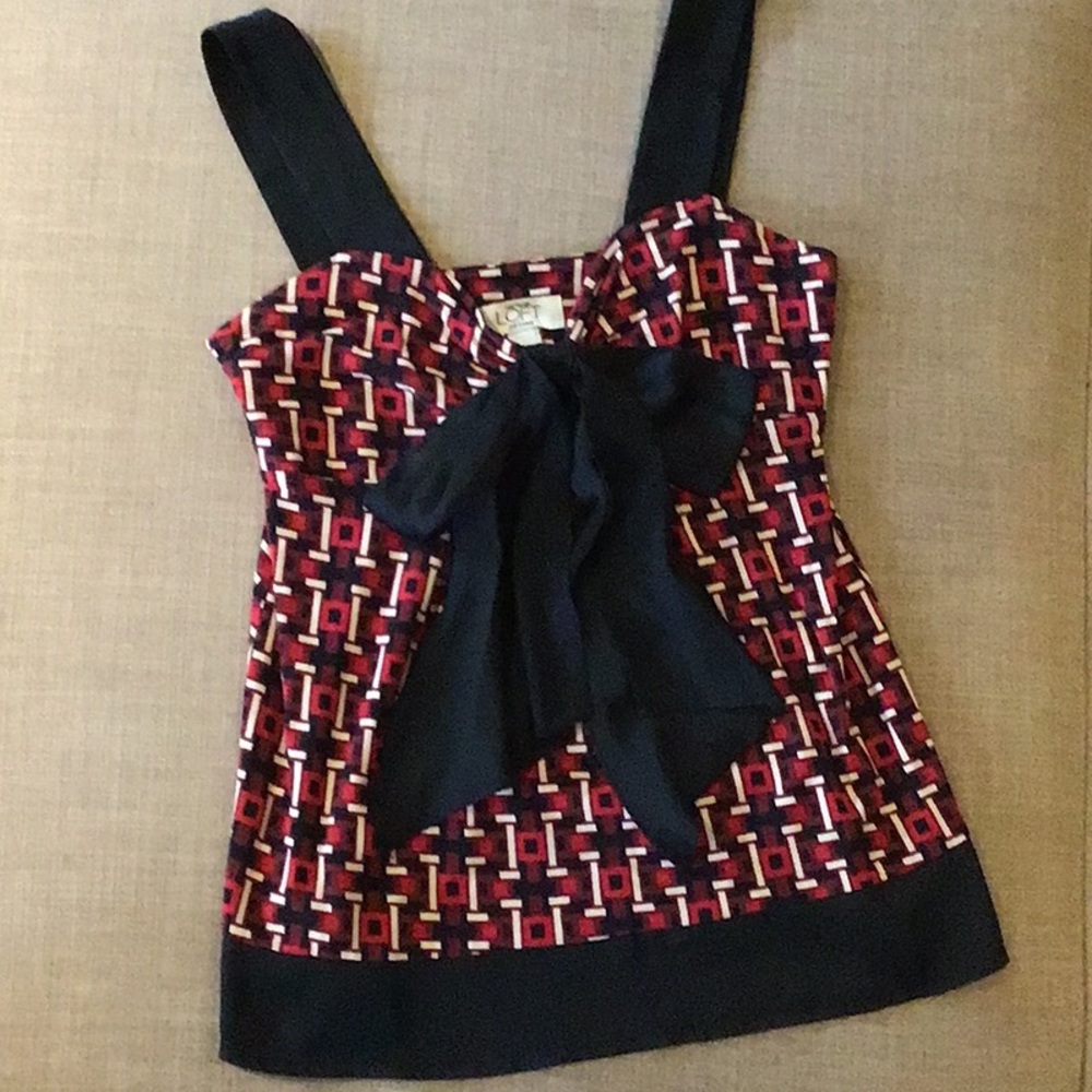 Sexy sophisticated shell. Great with your black blazer!